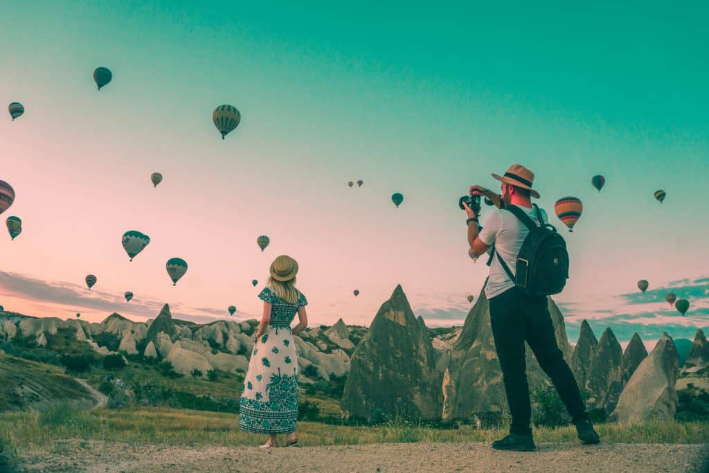 Ballons with a girl and a guy who is going to take better shots